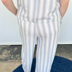 Striped tank and matching pants set. High neckline on top and regular fitting pants. Elastic waistline with tie.  White and tan in color.