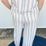 Striped tank and matching pants set. High neckline on top and regular fitting pants. Elastic waistline with tie.  White and tan in color.