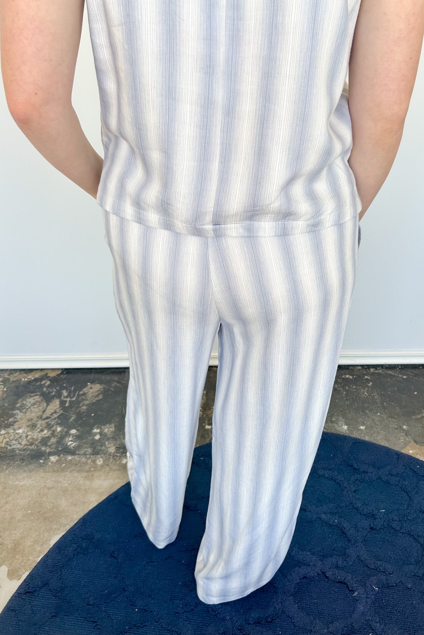 Striped tank and matching pants set. High neckline on top and regular fitting pants. Elastic waistline with tie.  White and tan in color.