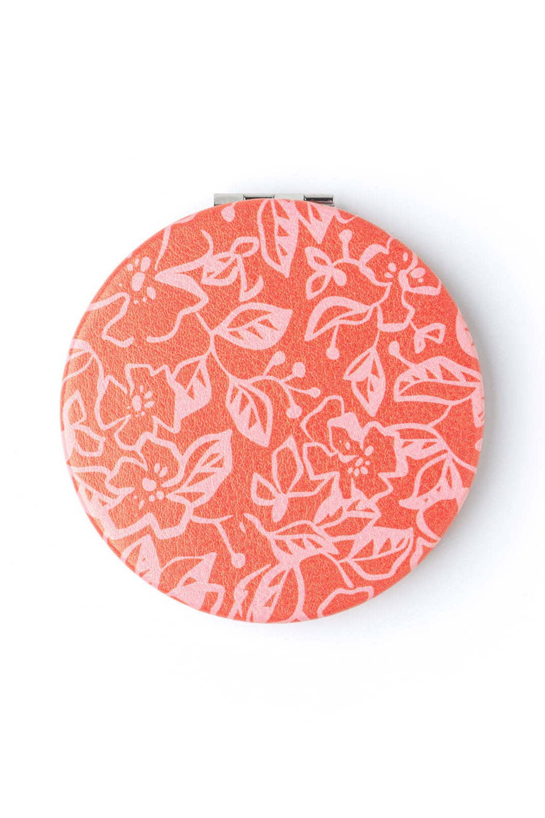 Round compact mirror with floral pattern on a white background