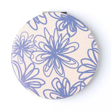 Round compact mirror with blue floral pattern on a beige background