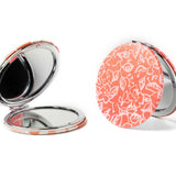 Compact mirror with floral pattern on a white background