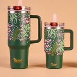 Set of three green tumblers with floral designs on a beige background