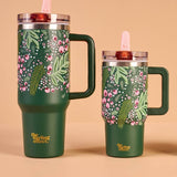 Set of three green tumblers with floral designs on a beige background