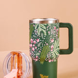 Green floral-patterned mug with handle on a beige background
