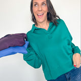 Woman holding a purple garment with blue gloves against a white background