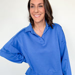 Woman wearing a blue sweater against a white background