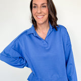 Woman wearing a blue sweater against a white background