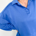 Person wearing a blue shirt with a white background