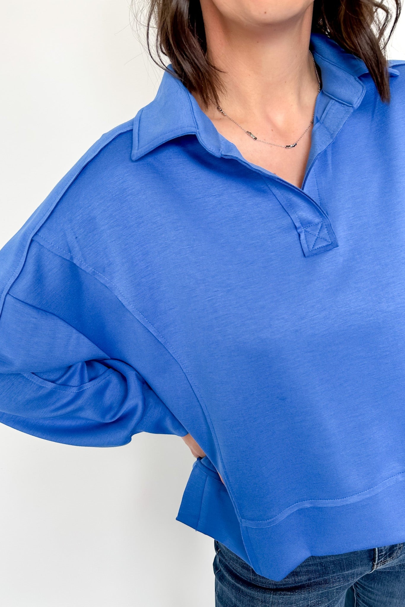 Person wearing a blue shirt with a white background