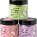 Three jars of 'let's get steamy' shower steamers with colorful labels on a white background.