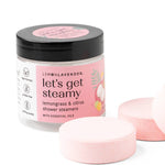 Jar of 'let's get steamy' shower steamers with pink packaging on a white background