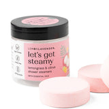 Jar of 'let's get steamy' shower steamers with pink packaging on a white background