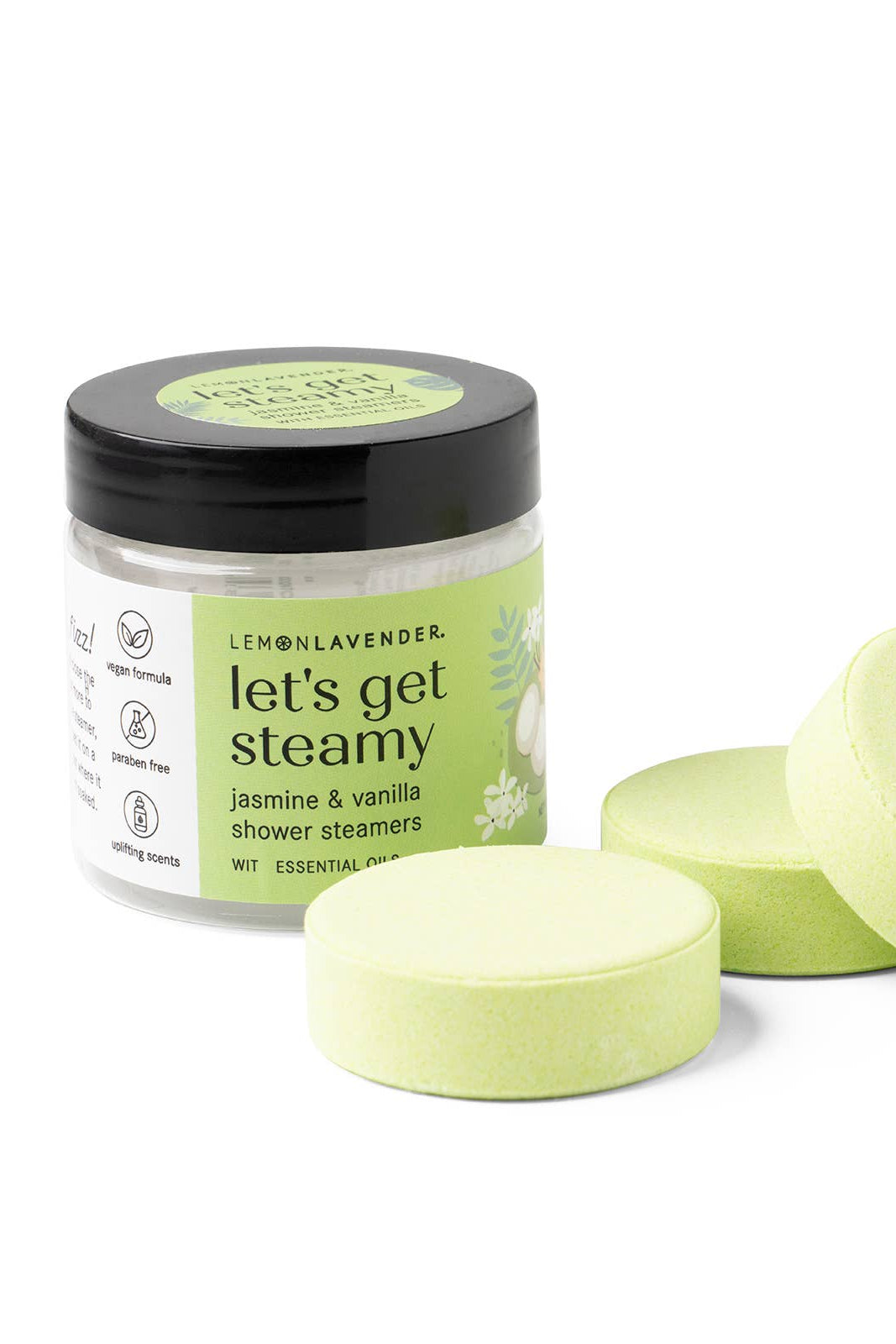 Jar of 'let's get steamy' shower steamers with three green tablets on a white background
