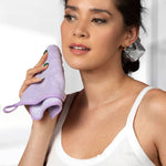 Woman holding a purple scrubber against a white background