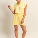Creamy yellow hooded romper with a functional zipper and pockets. Comfortable and casual look. 