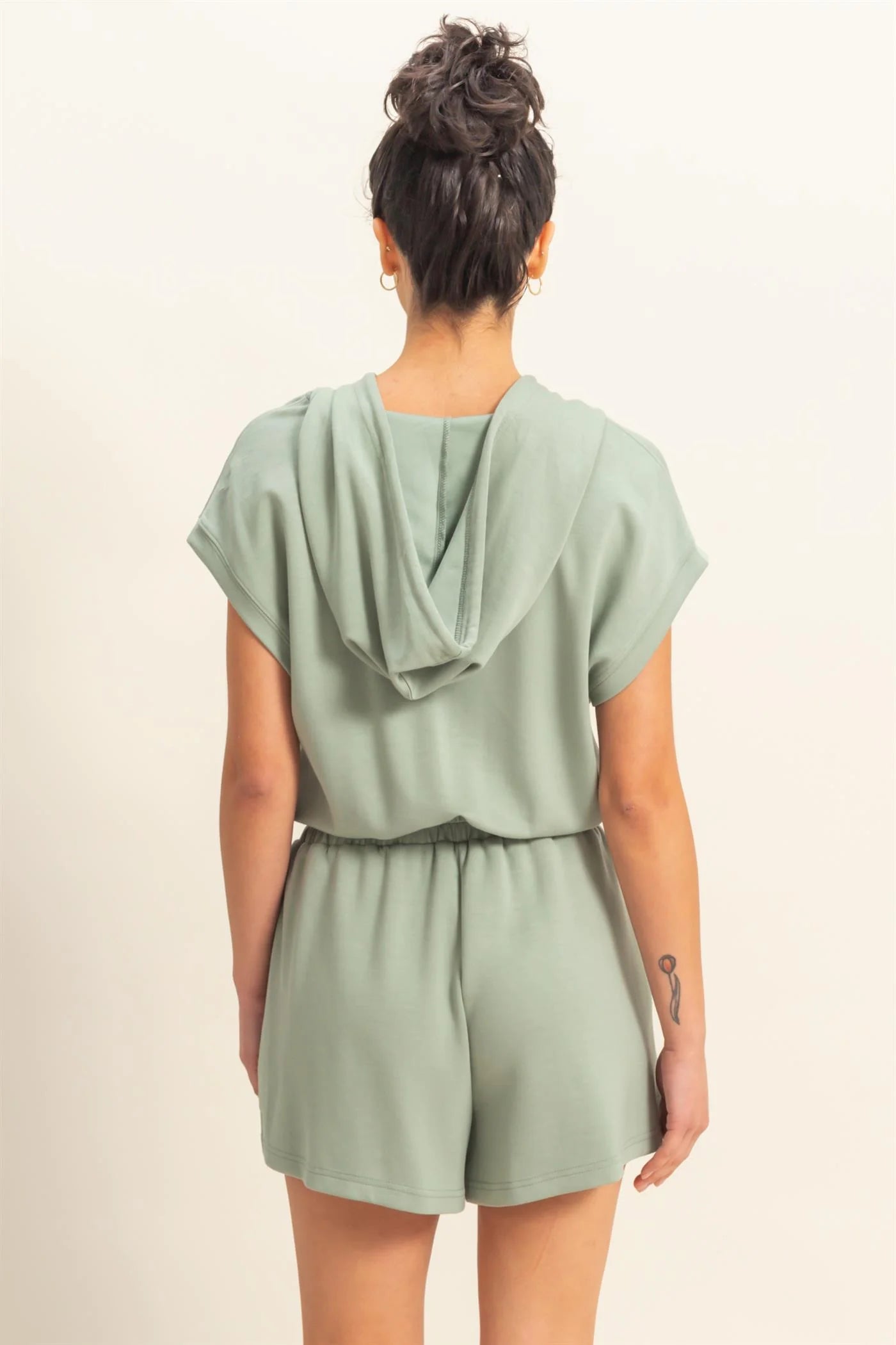 Sage green romper with functional zipper and pockets. Casual comfortable style.
