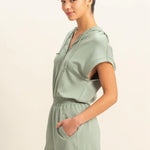 Sage green romper with functional zipper and pockets. Casual comfortable style.