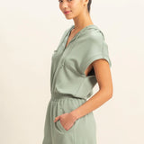 Sage green romper with functional zipper and pockets. Casual comfortable style.