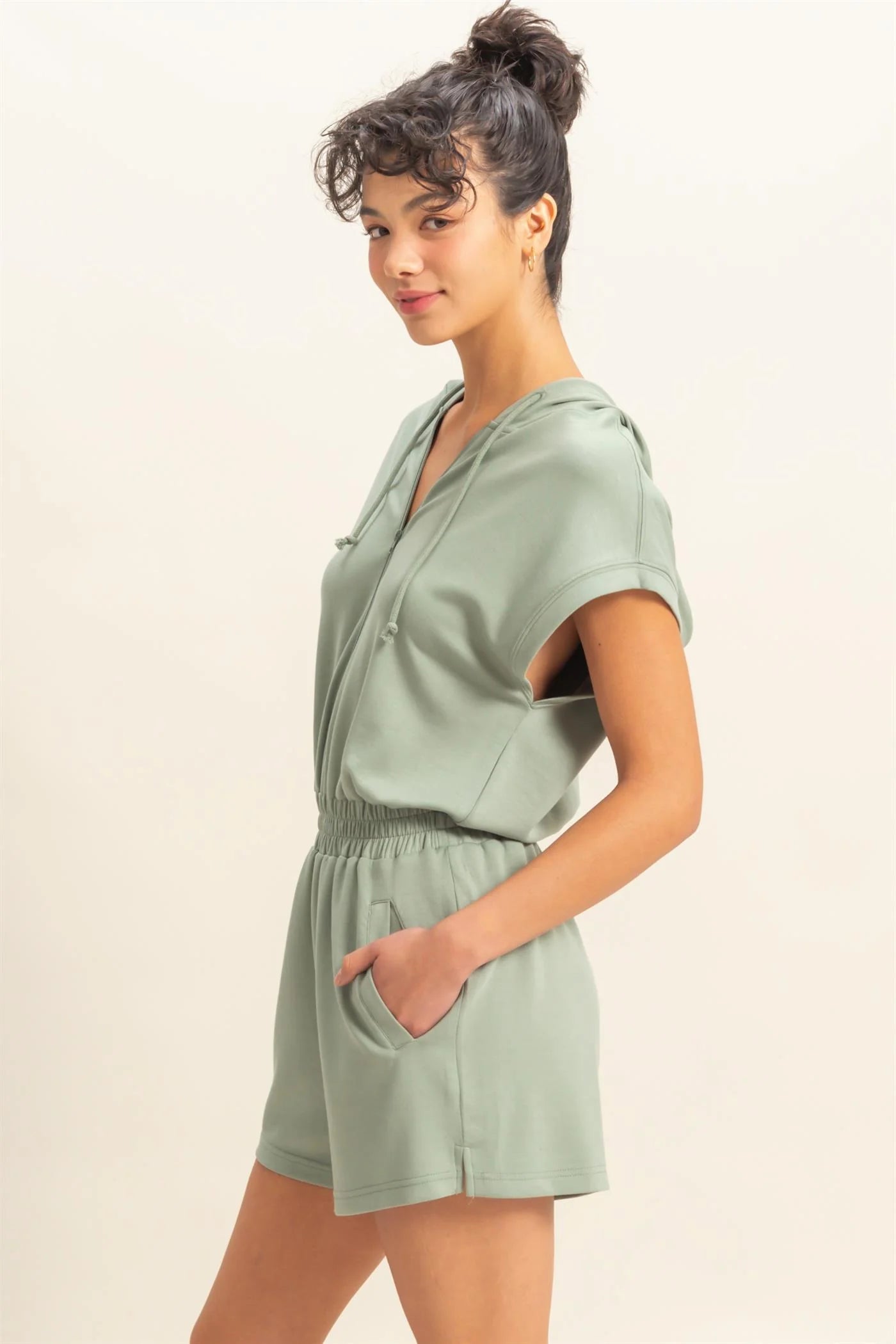 Sage green romper with functional zipper and pockets. Casual comfortable style.