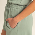 Sage green romper with functional zipper and pockets. Casual comfortable style.
