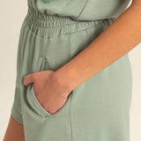Sage green romper with functional zipper and pockets. Casual comfortable style.