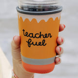 Hand holding a tumbler with 'teacher fuel' text on an orange sleeve against a white background