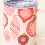 Pink mug with Christmas ornament pattern on a white background