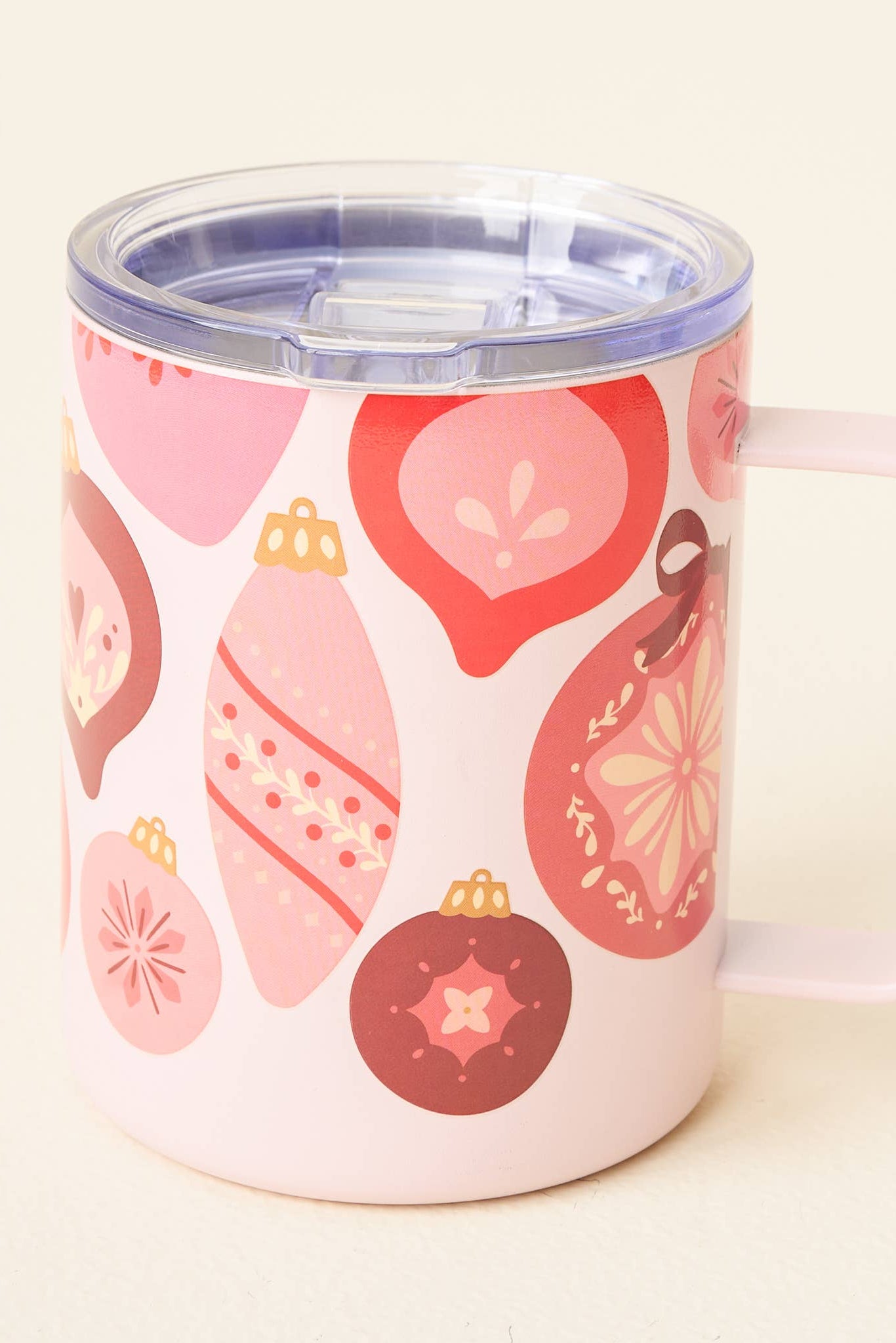 Pink mug with Christmas ornament pattern on a white background