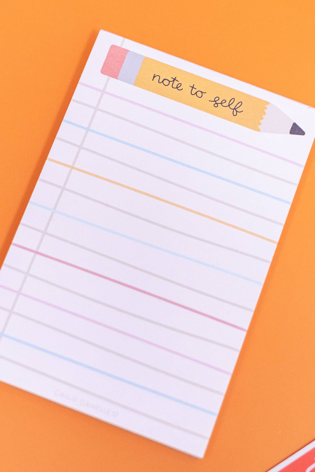 Note to self notepad with colorful border on an orange background