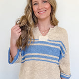 Woman wearing a striped sweater and jeans against a white background