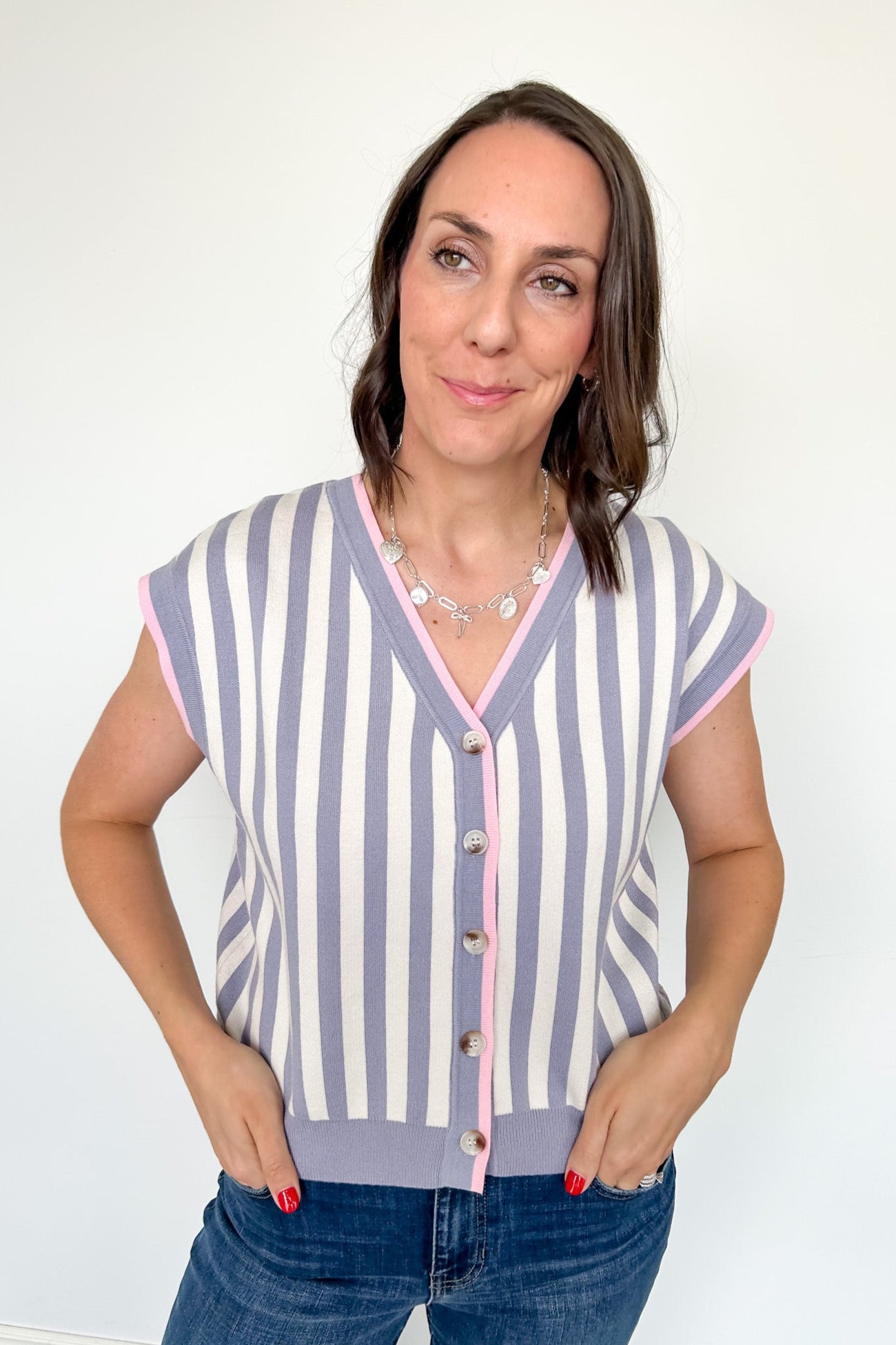 Woman wearing a striped cardigan with a white background