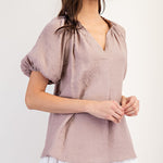 Mauve colored top with a v neckline and puff sleeve detailing. Regular fitting top. Blouse style.