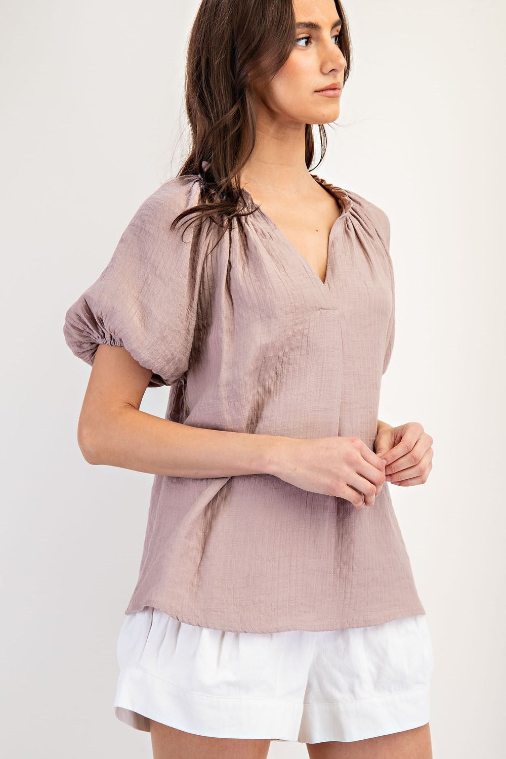 Mauve colored top with a v neckline and puff sleeve detailing. Regular fitting top. Blouse style.