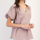 Mauve colored top with a v neckline and puff sleeve detailing. Regular fitting top. Blouse style.