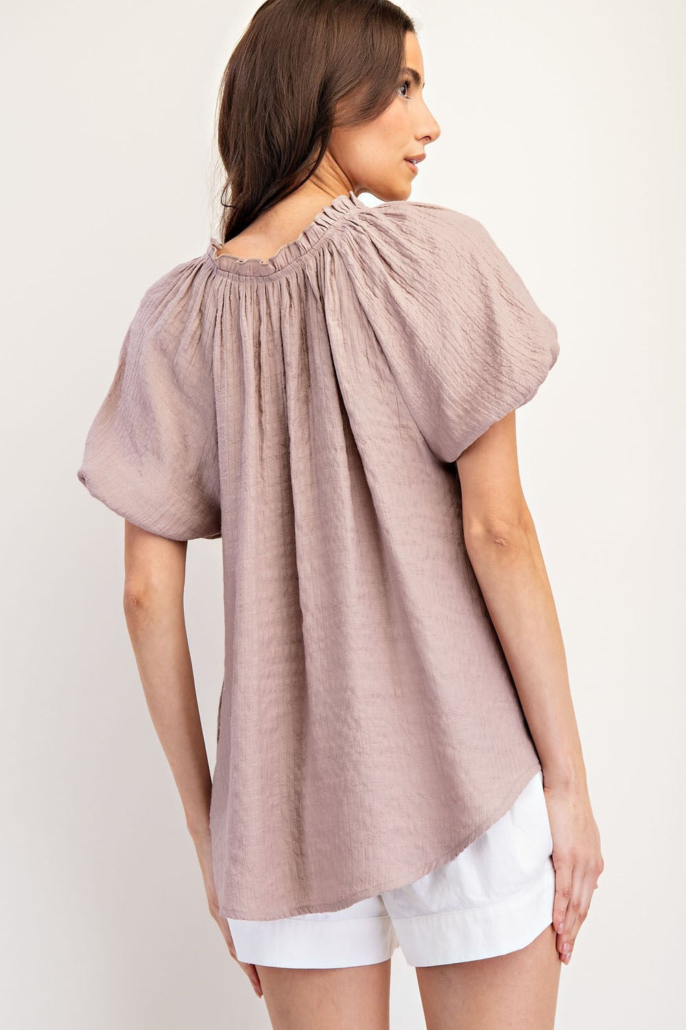 Mauve colored top with a v neckline and puff sleeve detailing. Regular fitting top. Blouse style.