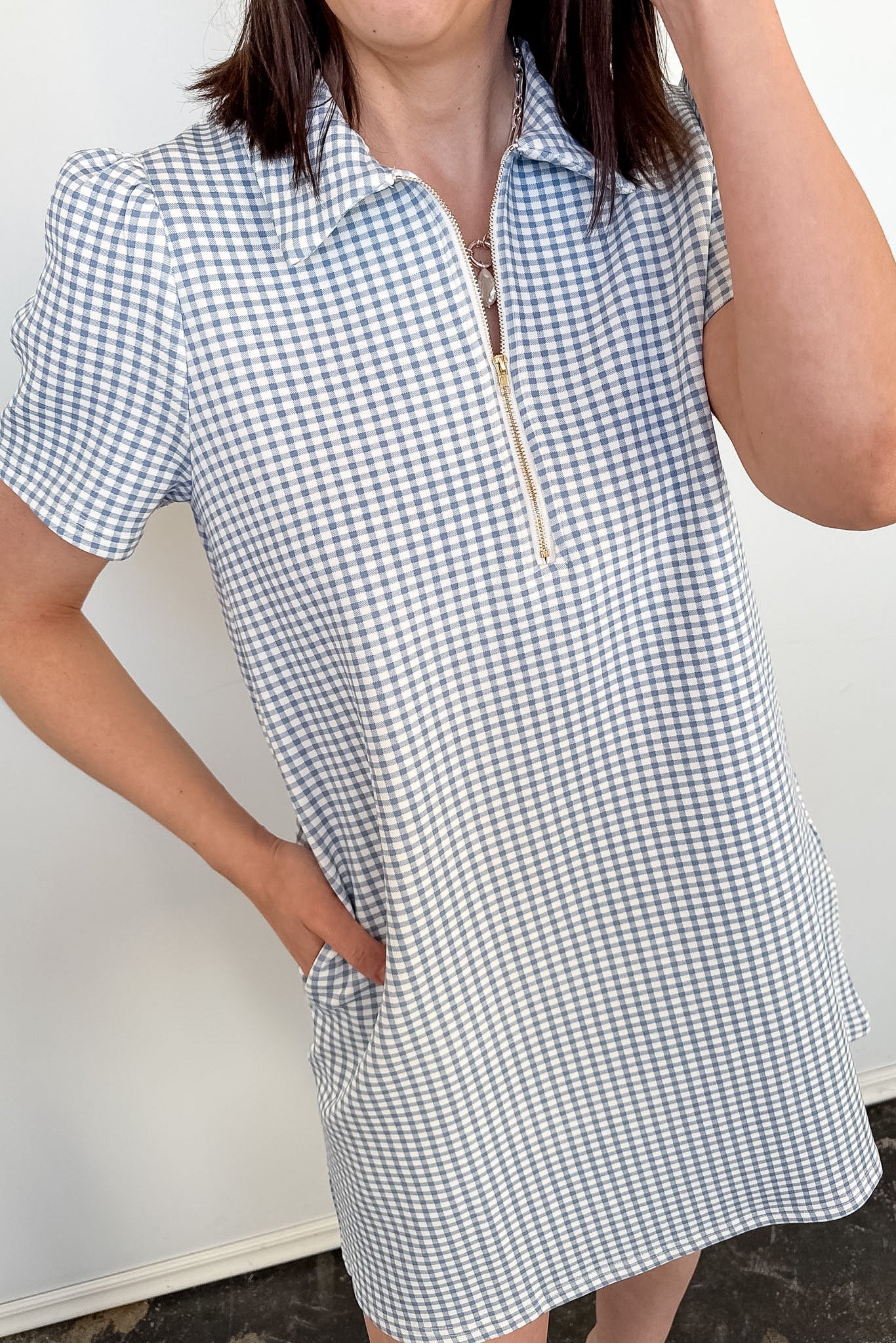 Person wearing a checkered dress with a white background
