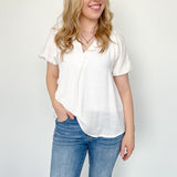 White colored top with a v neckline and puff sleeve detailing. Regular fitting top. Blouse style.