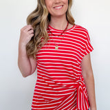 Woman wearing a red and white striped top against a white background