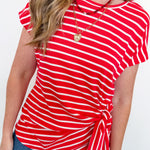 Person wearing a red and white striped shirt with a white background