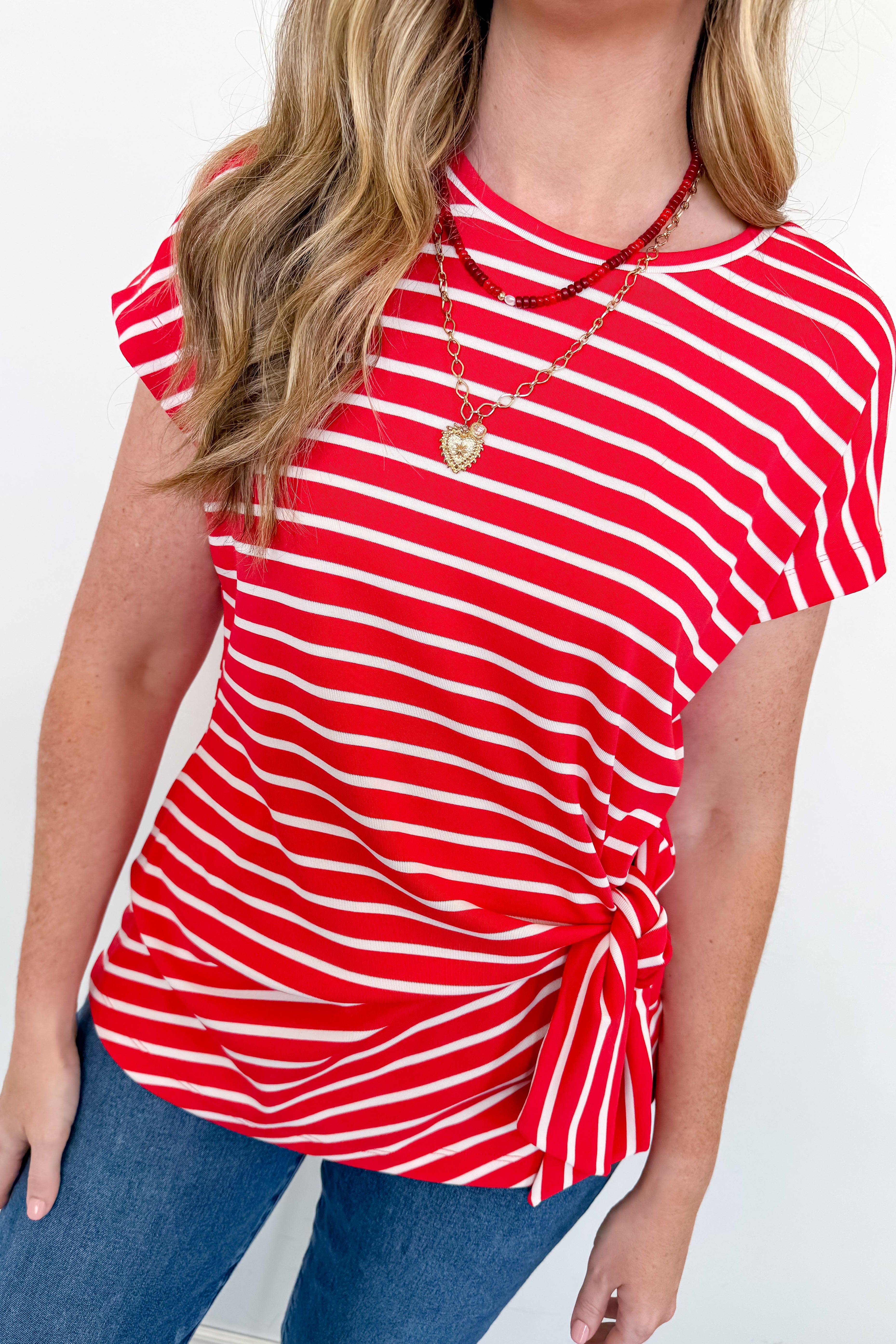 Person wearing a red and white striped shirt with a white background