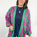 Woman wearing a colorful cardigan with a white background