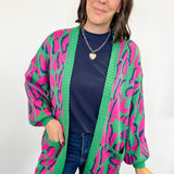 Woman wearing a colorful cardigan with a white background