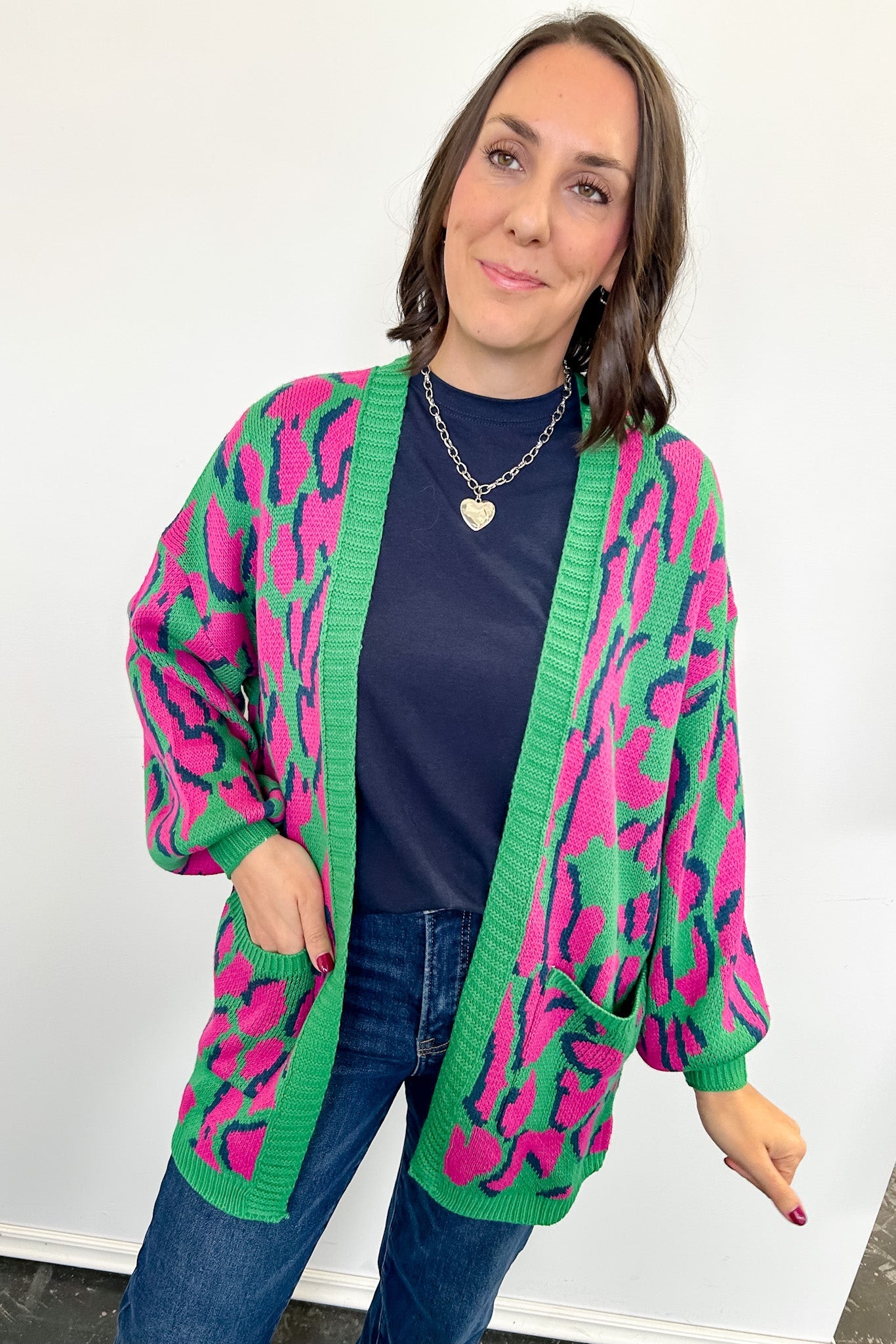 Woman wearing a colorful cardigan with a white background