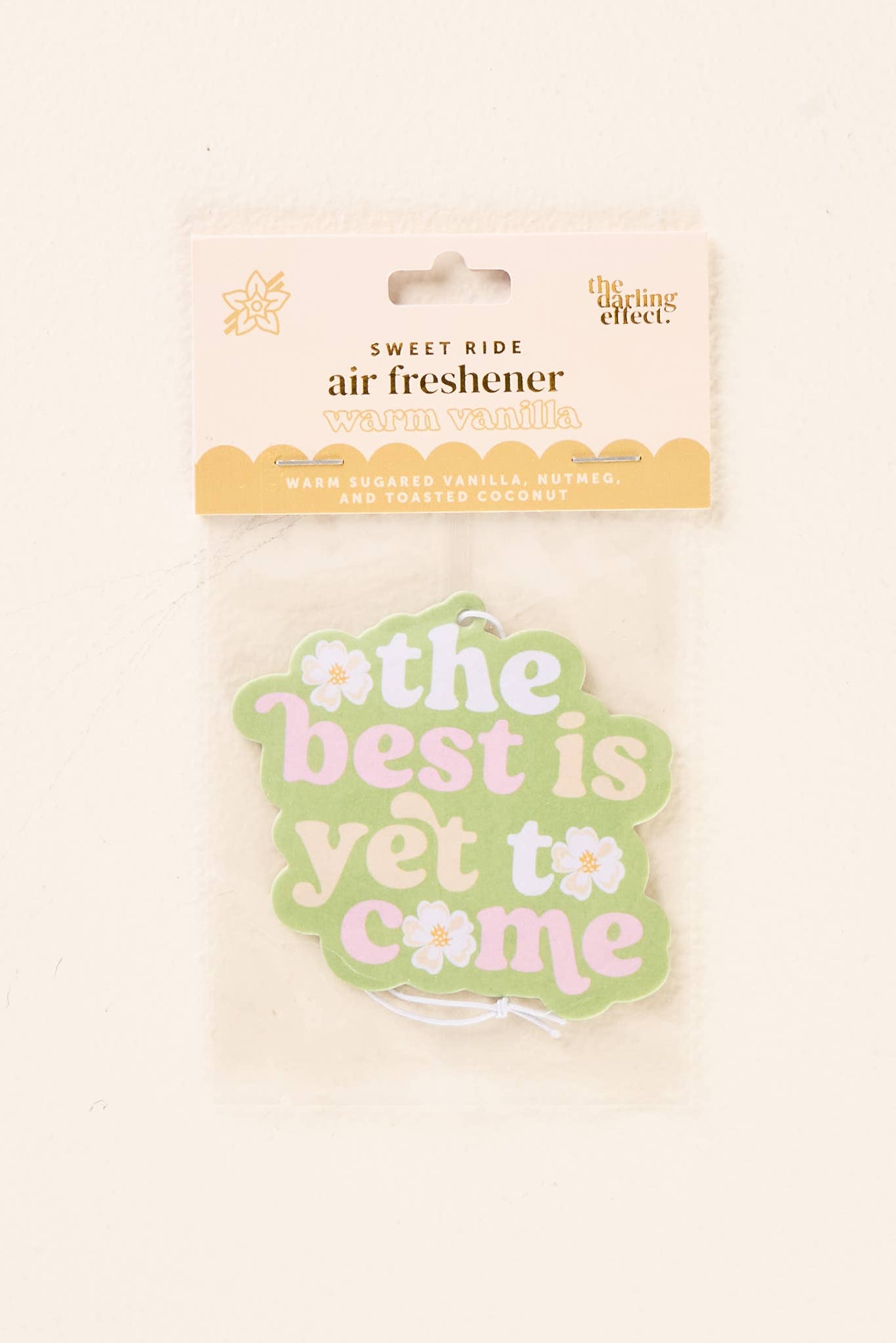 Air freshener with 'the best is yet to come' text on a light background