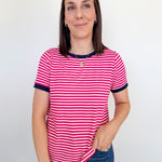 Woman wearing a pink and white striped shirt against a plain background