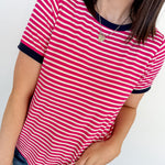 Person wearing a red and white striped shirt with blue jeans against a white background