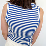 Woman's back in a blue and white tank top.