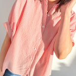 Person wearing a red and white striped shirt against a white background