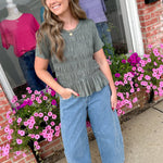 Woman standing outside a store with floral decorations